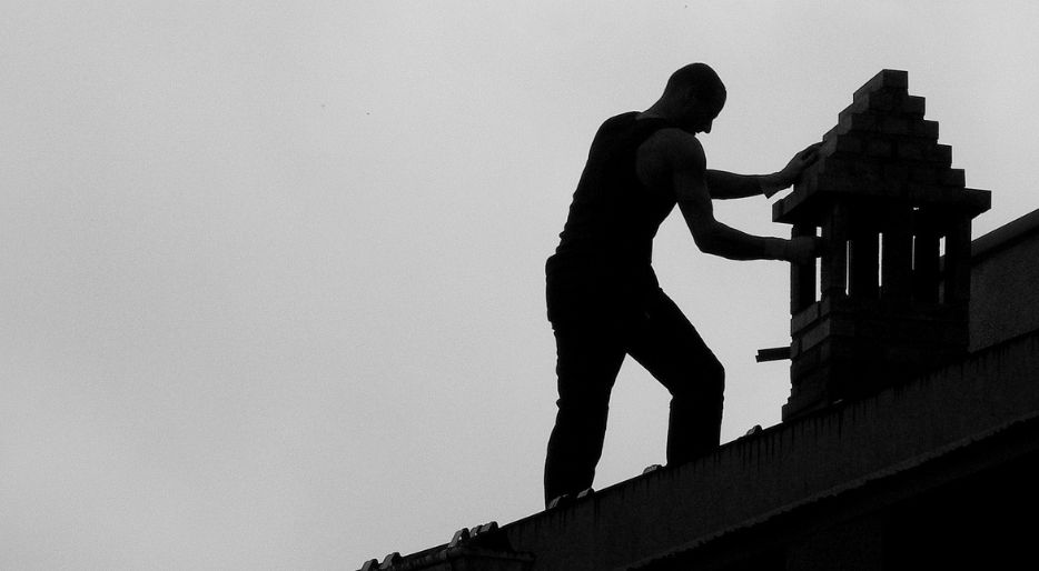 professional chimney sweep cleaning a chimney